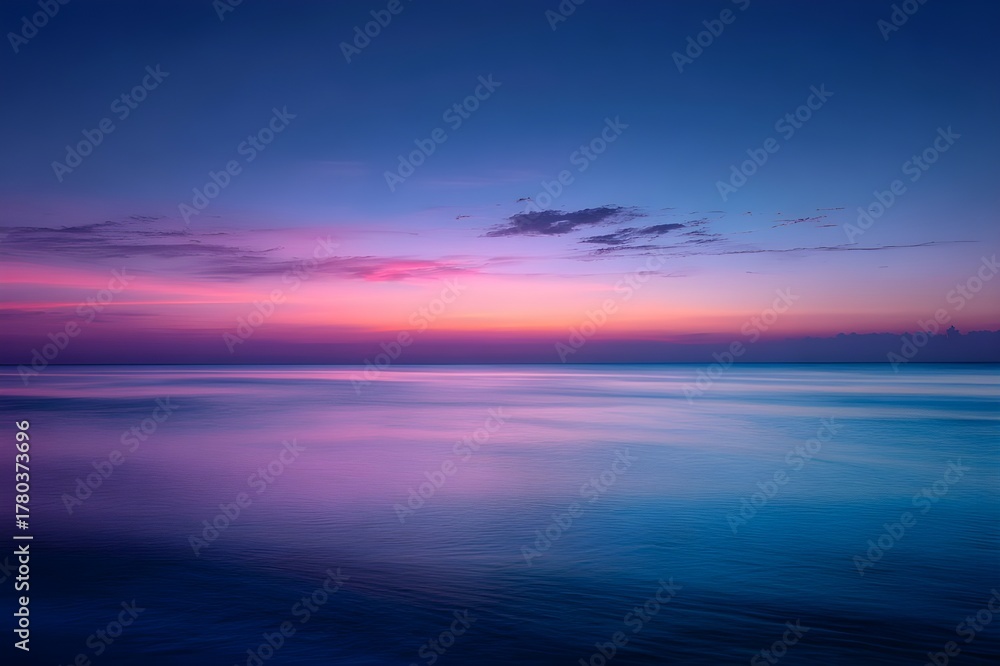 Fototapeta premium Sunset Over Calm Ocean with Gradient Sky from Pink to Deep Blue Horizon Peaceful Scene
