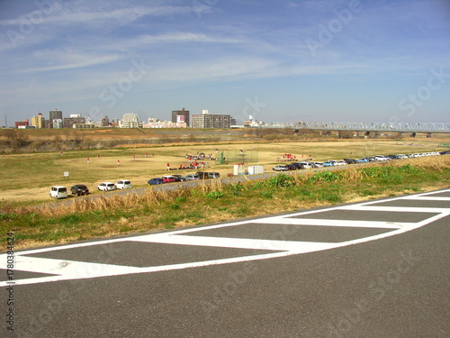 休日の野球を楽しむ早春の江戸川河川敷風景