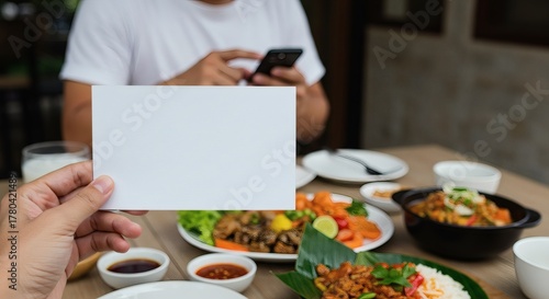Wallpaper Mural Hand holding blank card over a table full of delicious food Torontodigital.ca