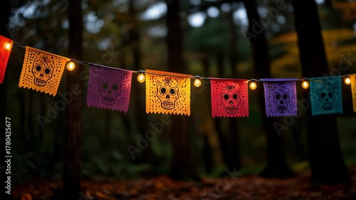 Colorful Papel Picado Banners with Skulls Illuminated by String Lights in Autumn