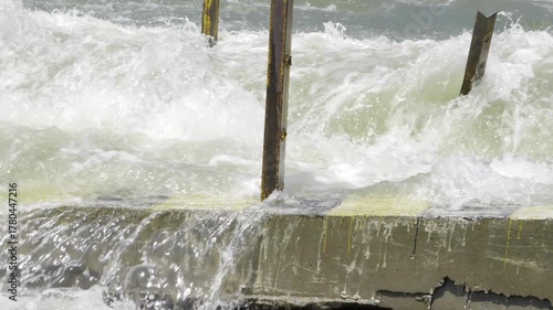 Vibrant Ocean Waves and a Sturdy Fence - Captivating Coastal Scenery