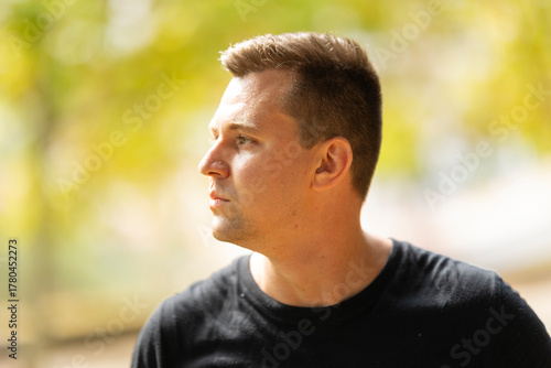 Young man looking away with confident expression outdoors