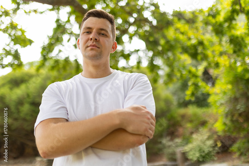 Confident man crossing arms looking at camera