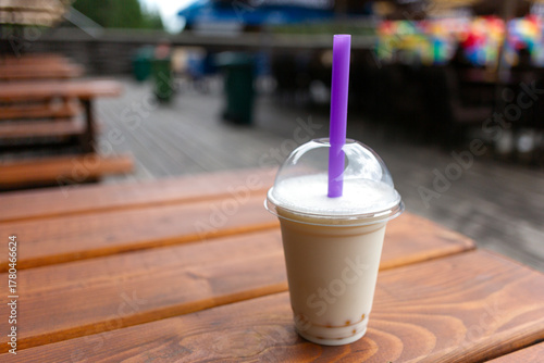 Milkshake in a glass with a straw