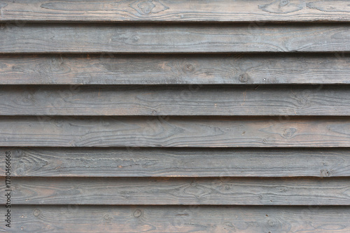 Horizontal, smooth, gray wooden planks as a background, texture, pattern.