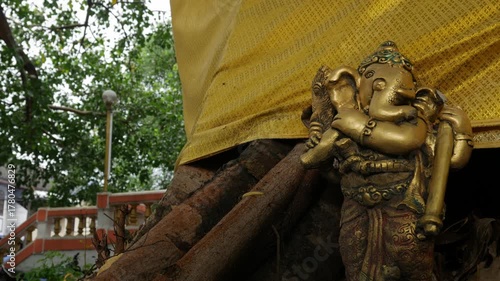 Vintage Hindu Elephant God Sculpture with Ornate Details and Gold Decorative Backdrop