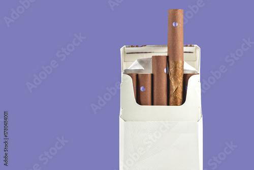 Open pack of 10 cigarillos against a purple background, showing detail of brown cigar wrappers,tobacco habit, addiction awareness, and smoking culture concept.