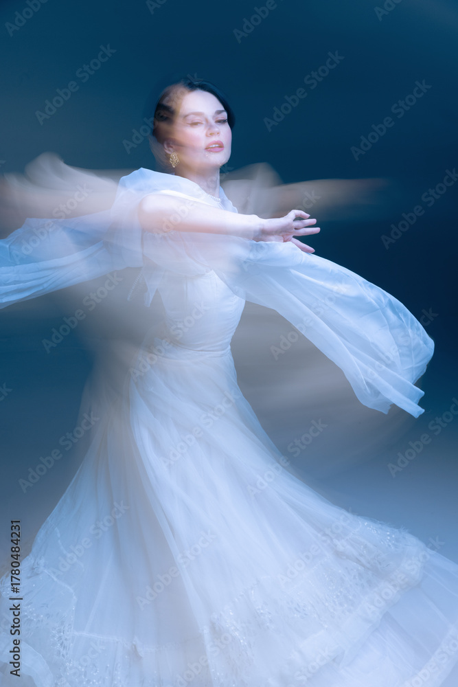 Naklejka premium Expressive dancer in white gown, arms extended through luminous motion blur. Concept of high-end fragrance, decor identity, and emotional mindfulness through dynamic elegance.
