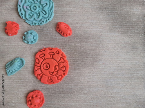 Covid and other respiratory virus molecules made of plasticine. Little toddler education moment in a playful mode. Bacteria made of playdough.