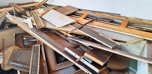 A pile of broken furniture. Dismantling wooden furniture before renovation. Panorama.
