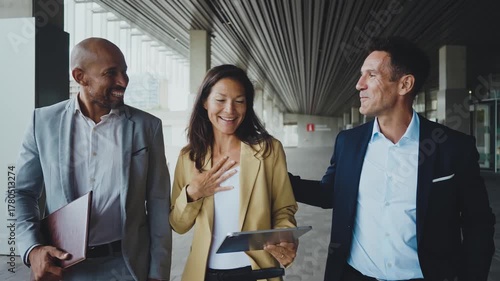 Business people meeting in a business park - Corporate businessmen and businesswoman bonding outdoors, colleagues meeting after work.
