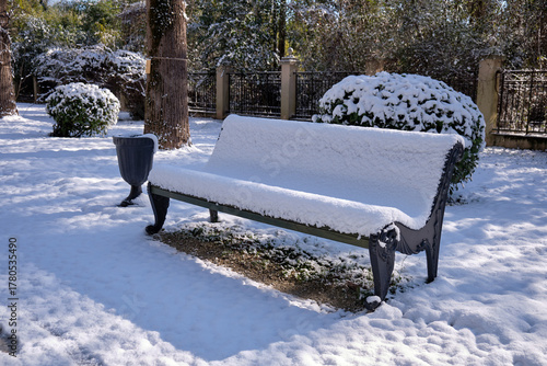 Bild auf Leinwand The snow-covered bench in park. Sirius. Krasnodar Krai. Russia