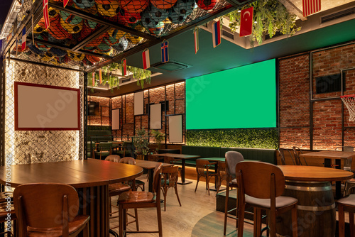 Sports lounge interior with brick walls, multiple TVs, and wood accents