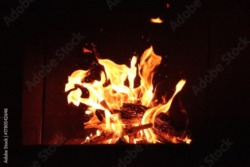 Fire in an oven in front of a black background