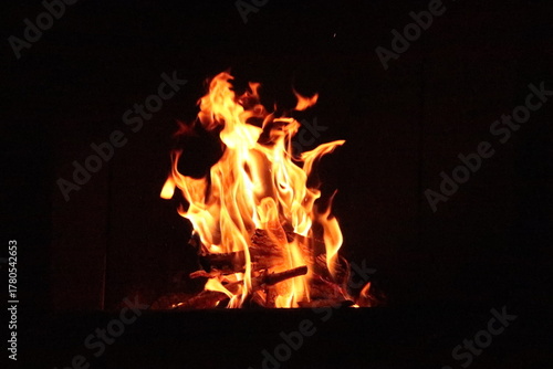 Fire in an oven in front of a black background