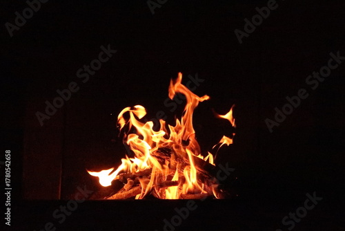 Fire in an oven in front of a black background