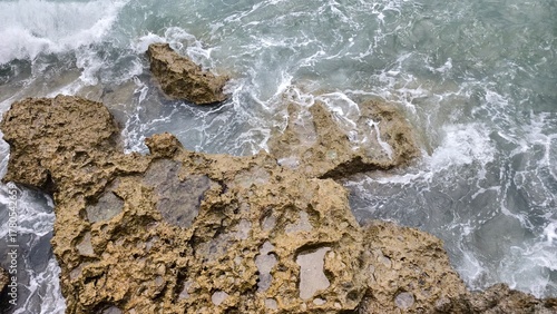 Ocean Waves and Textured Coastal Rocks