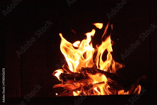 Fire in an oven in front of a black background