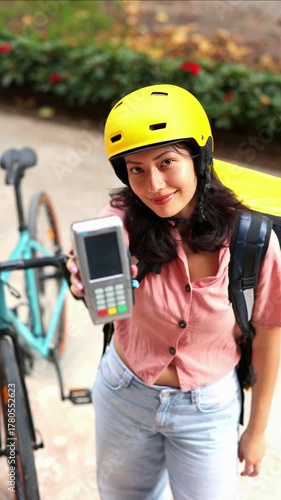 vertical Asian delivery woman accepting credit card payment