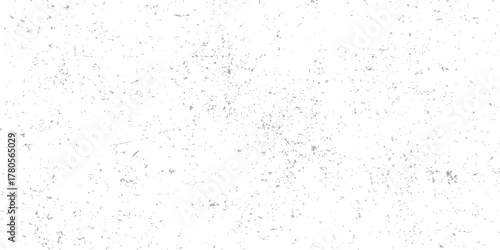 Roughly textured white paint on an old, blank concrete wall surface creates a vintage grunge background design