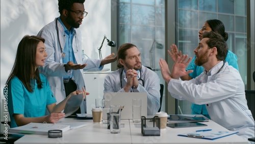 Stressed arguing diverse five people multiethnic group of doctors medical students interns debate discuss quarrel about health examination diagnosis diagnostic team brainstorm at meeting room hospital