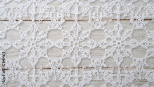 Closeup of intricate white crochet lace pattern on a wooden background