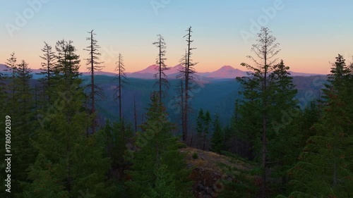 Three Sisters aerial drone shot with Oregon forest and soft sunset tones