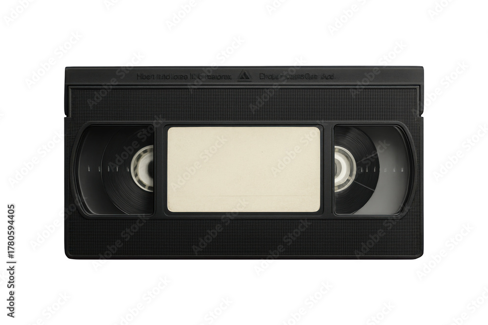 Obraz premium Close up of a black vintage vhs tape with a blank label in the center against a stark black background