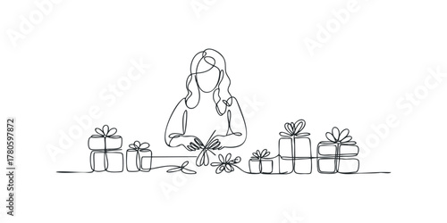 Woman preparing gifts by tying ribbons on boxes