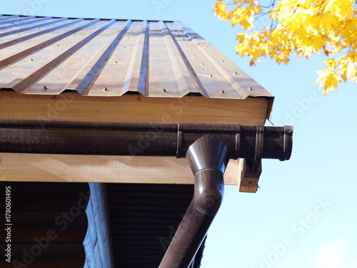 Rain Gutter Pipeline System Installation. Roofing Construction.