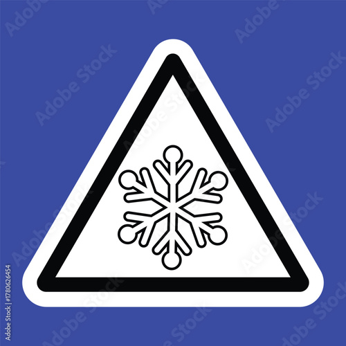 Triangular warning sign with a black snowflake symbol on a white background and blue border, indicating icy or cold surface caution. Ideal for safety signage and winter hazard alerts.
