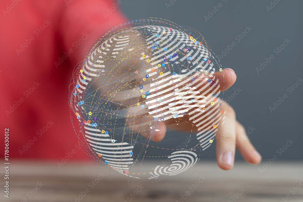 Obraz premium Close-up of a person's hand holding a digitally rendered world globe illustrating global connection and communication. Technology and