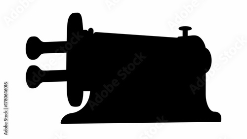 Silhouette of an antique sewing machine with visible knobs and a single button on top of the machine