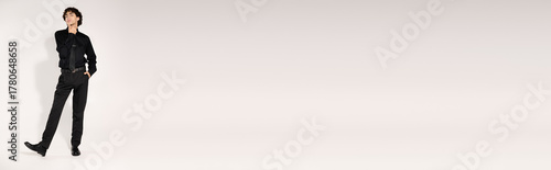 Φωτογραφία Stylish young man exuding confidence in trendy black fashion attire against mini