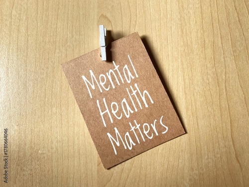 Brown note card with the phrase 'Mental Health Matters'. Refers to the mental health awareness, the importance of wellbeing, and the need for prioritizing psychological health.