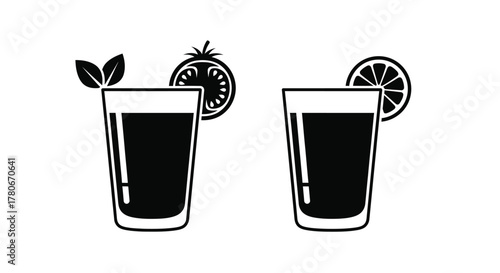 Two glasses of dark liquid with citrus and leaf garnishes shown