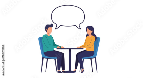 Two people seated at a table engaged in a conversation