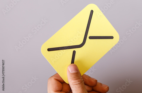 A hand holding a stylized y...