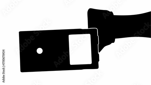 Silhouette of a vintage camera with a flash attachment in black and white photography style