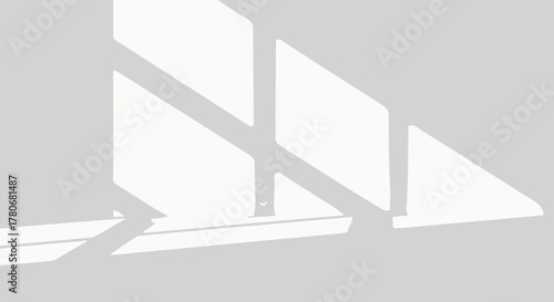 Abstract interplay of sunlight and shadows creating minimalist patterns on a neutral surface