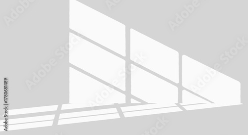 Subtle interplay of sunlight casting linear shadows on a light gray interior wall adding