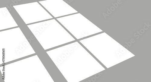 Geometric window shadows cast a soft pattern on a minimalist neutral surface plain and simple