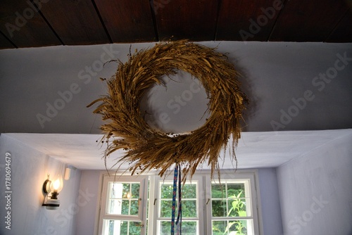 A wreath of dried flowers hung on the wall.