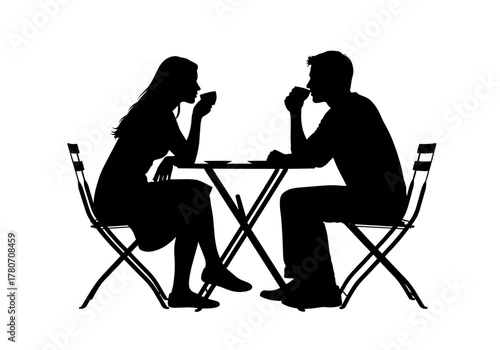 Silhouette of a couple enjoying coffee at an outdoor cafe