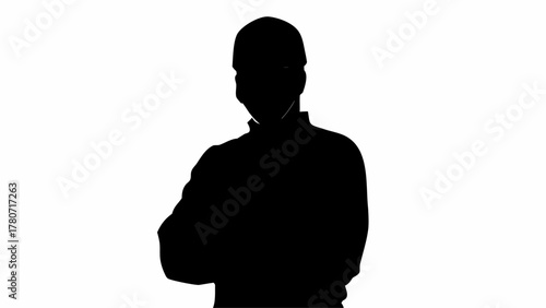 Silhouette of a person with arms crossed against a white background creating a stark contrast view