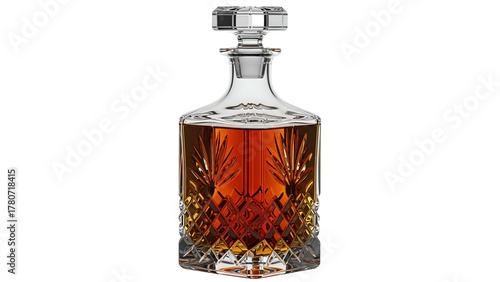 Ornate crystal beverage container holds amber liquid against a deep black background