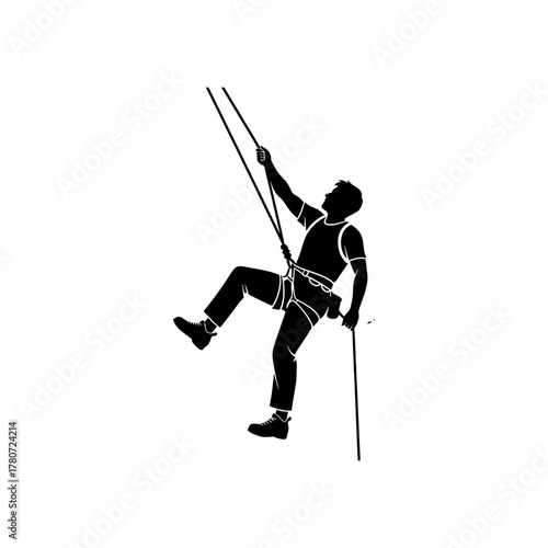 Silhouette of climber ascending steep rock face using ropes and safety equipment, showcasing determination and adventure in outdoor sport.