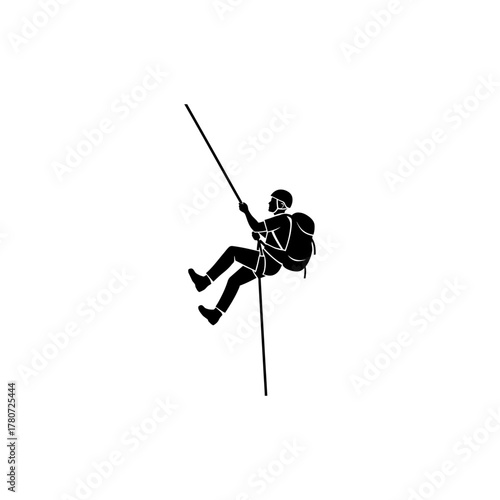 Silhouette of climber rappelling down cliff face with backpack and helmet during outdoor adventure, showcasing determination and skill.