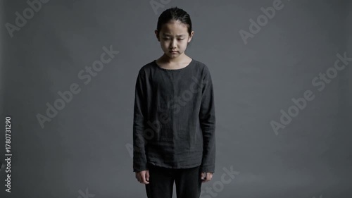 Sad thoughtful person standing over gray background pessimistic mood concept