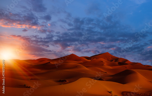 Sand dunes in the Sahara Desert at amazing sunrise, Merzouga, Morocco - Orange dunes in the desert of Morocco - Sahara desert, Morocco